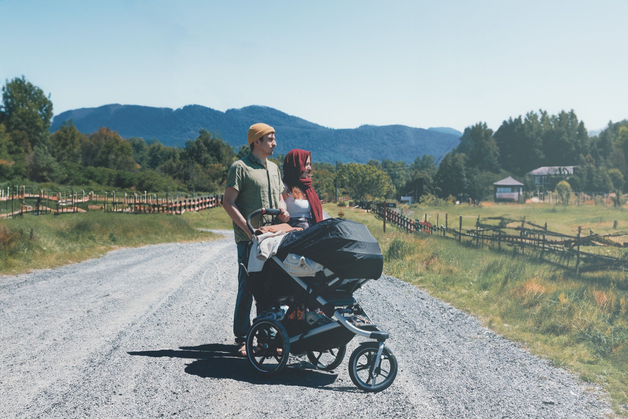 Parents with a pushchair on a countryside path