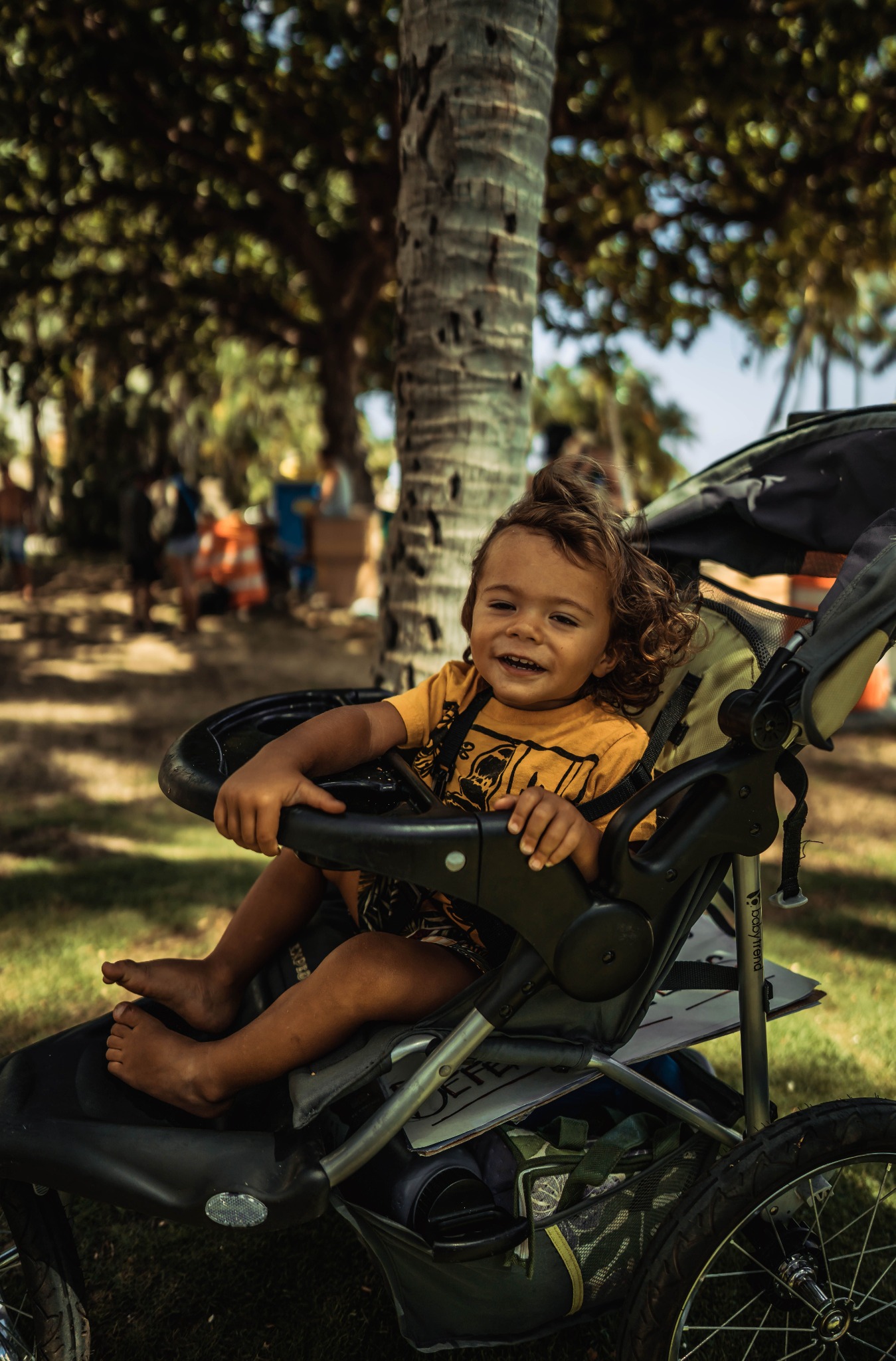 Parent walking with a child in a buggy